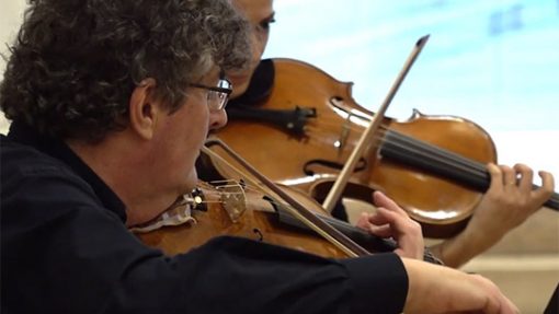 Gros plan sur deux violonistes en train de jouer